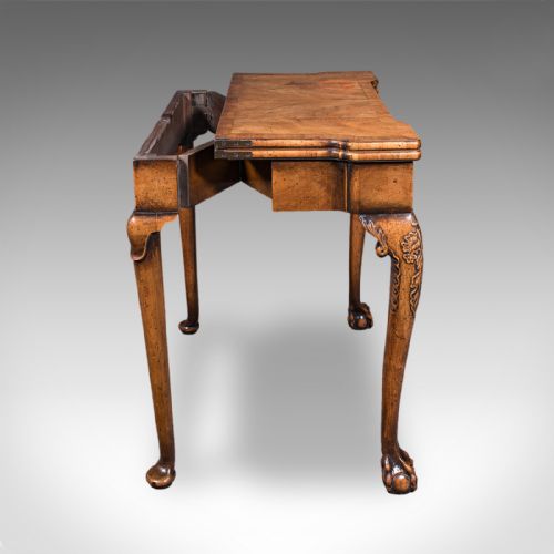 fig 4. An antique English Georgian walnut card table featuring cabriole legs with carved knees, claw and ball feet, and a square green baize playing surface.