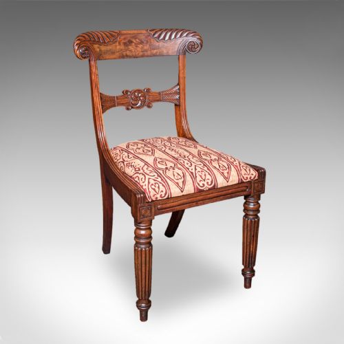 fig 2. A pair of English William IV mahogany side chairs featuring carved back rails, reeded front legs, and pattern-upholstered seats.
