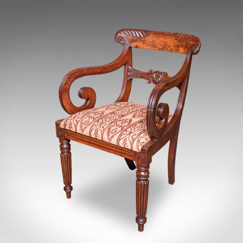 fig 4. A pair of antique William IV mahogany elbow chairs featuring carved crest rails, sweeping scroll arms, fluted turned front legs, and patterned upholstery.