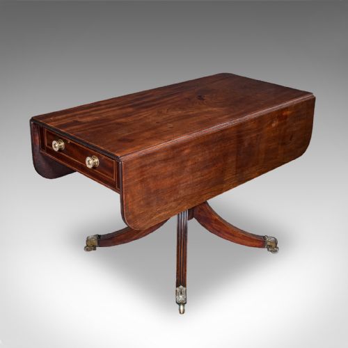 fig 1. A Regency dark mahogany drop-leaf Pembroke dining table with a central reeded pedestal, four splayed legs with brass castors, and a frieze drawer.