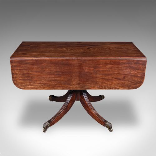 fig 2. A Regency dark mahogany drop-leaf Pembroke dining table with a central reeded pedestal, four splayed legs with brass castors, and a frieze drawer.