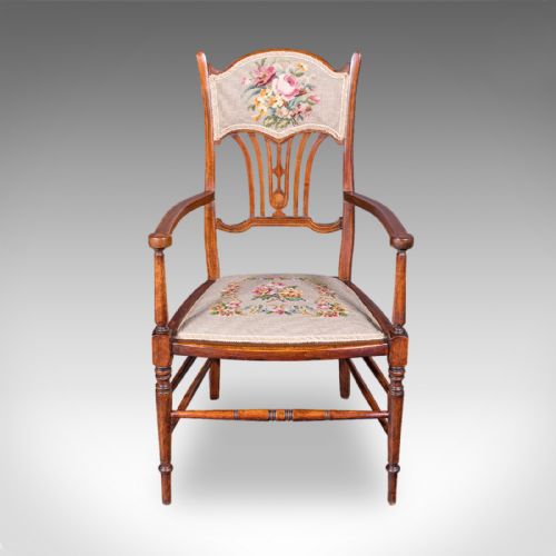 fig 1. An Art Nouveau beech elbow chair featuring a floral tapestry upholstered seat and backrest panel alongside turned front legs.