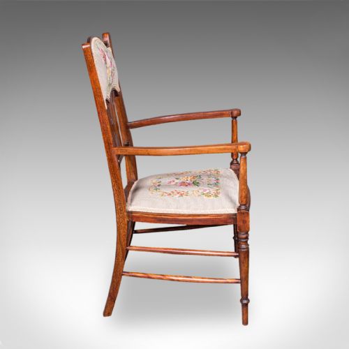 fig 2. An Art Nouveau beech elbow chair featuring a floral tapestry upholstered seat and backrest panel alongside turned front legs.