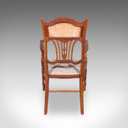 fig 3. An Art Nouveau beech elbow chair featuring a floral tapestry upholstered seat and backrest panel alongside turned front legs.
