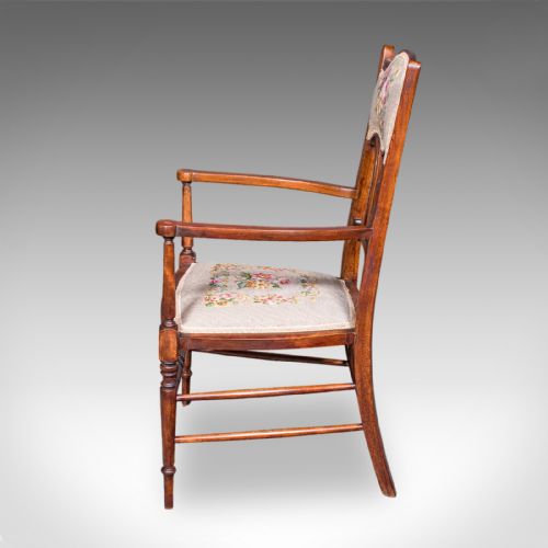 fig 4. An Art Nouveau beech elbow chair featuring a floral tapestry upholstered seat and backrest panel alongside turned front legs.