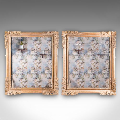 fig 1. A pair of large rectangular Regency style wall mirrors with ornate gold giltwood frames and floral corner embellishments.