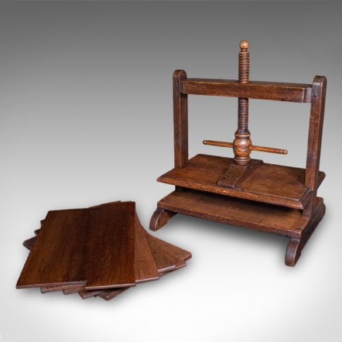 fig 1. A dark oak Georgian flower press with a central turned wooden screw mechanism and rectangular pressing boards.