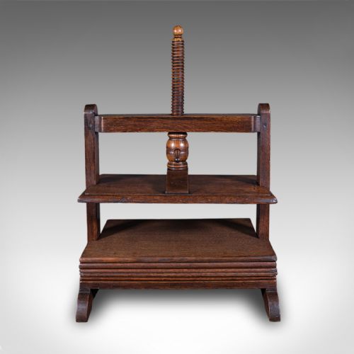 fig 2. A dark oak Georgian flower press with a central turned wooden screw mechanism and rectangular pressing boards.