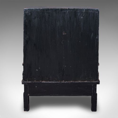 fig 4. An antique reddish-brown lacquered Chinoiserie campaign cabinet featuring gold gilt landscape scenes, brass corner mounts, and two open lower drawers on a matching stand.