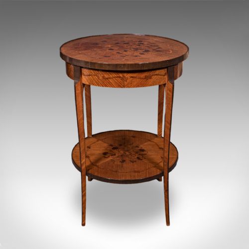 fig 1. A circular French style two-tier kingwood occasional table featuring intricate floral marquetry inlay on both surfaces and slender tapered legs.