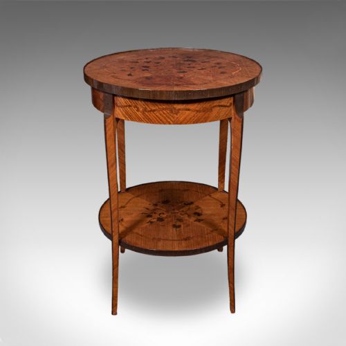 fig 2. A circular French style two-tier kingwood occasional table featuring intricate floral marquetry inlay on both surfaces and slender tapered legs.