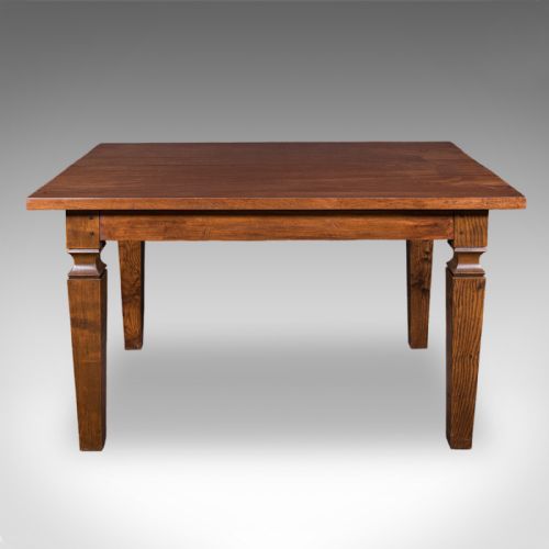 fig 1. An Edwardian rectangular walnut dining table featuring square tapered legs with shoulder moulding and a smooth wood top.
