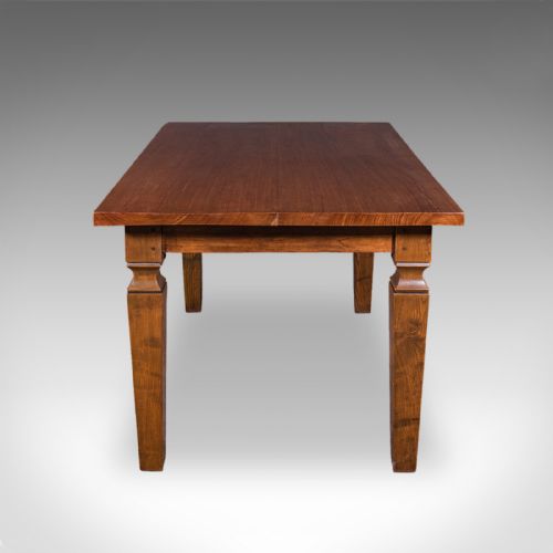 fig 2. An Edwardian rectangular walnut dining table featuring square tapered legs with shoulder moulding and a smooth wood top.