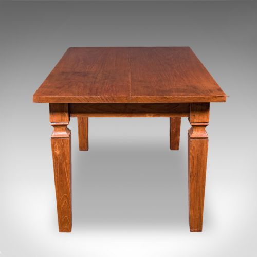 fig 2. An Edwardian rectangular English walnut dining table featuring tapered legs with carved collars and a smooth polished top.