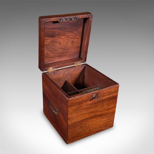 fig 1. A Georgian mahogany four-decanter storage box featuring a brass top plaque, side carrying handles, and a key inserted in the front lock.