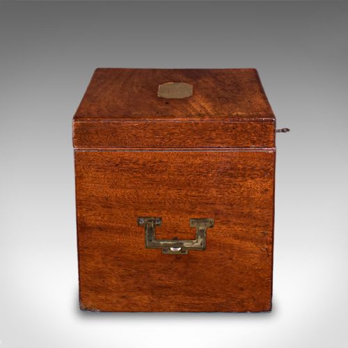 fig 3. A Georgian mahogany four-decanter storage box featuring a brass top plaque, side carrying handles, and a key inserted in the front lock.