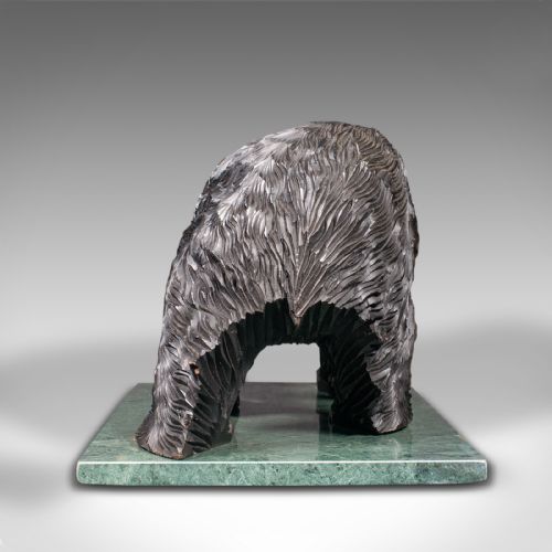 fig 3. A Japanese carved cedar bear holding a fish in its mouth mounted on a green polished stone base.