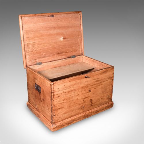 fig 1. An antique rectangular Victorian pine carriage chest with a hinged lid, side iron carry handles, and a lower plinth base.