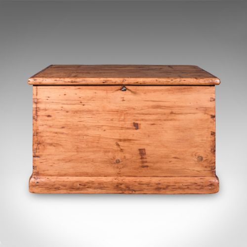 fig 2. An antique rectangular Victorian pine carriage chest with a hinged lid, side iron carry handles, and a lower plinth base.