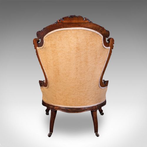 fig 5. An early Victorian carved mahogany salon armchair upholstered in gold velvet fabric accompanied by a matching small footstool.
