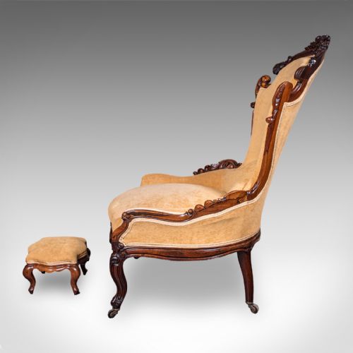 fig 6. An early Victorian carved mahogany salon armchair upholstered in gold velvet fabric accompanied by a matching small footstool.