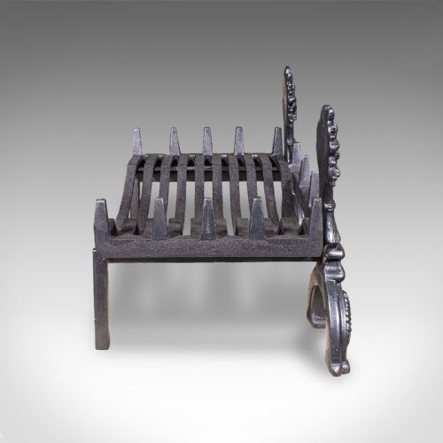 fig 2. Victorian cast iron fire basket featuring curved grate bars and integrated front andirons decorated with wheat sheaf motifs.