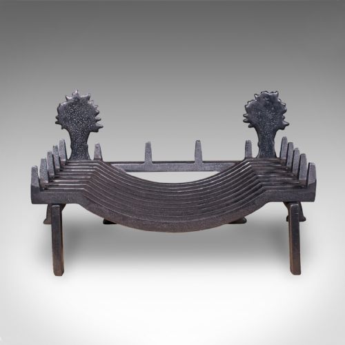 fig 3. Victorian cast iron fire basket featuring curved grate bars and integrated front andirons decorated with wheat sheaf motifs.