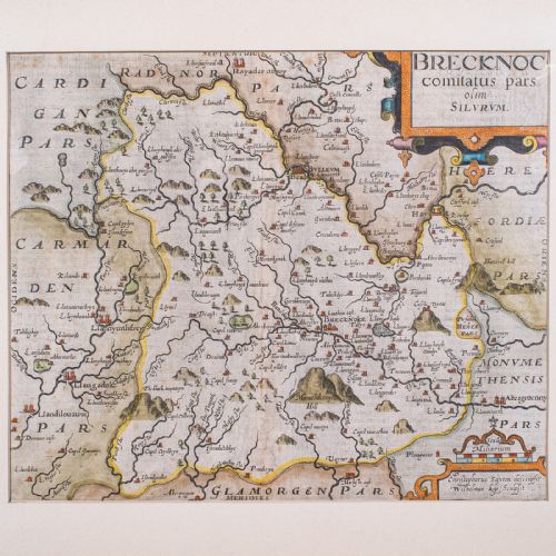 fig 3. A framed 1607 hand-coloured antique map of Brecknoc set within a cream mount and a dark frame with gold trim.