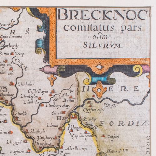fig 4. A framed 1607 hand-coloured antique map of Brecknoc set within a cream mount and a dark frame with gold trim.