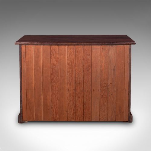 fig 4. A low Victorian Gothic Revival wooden cabinet with double doors featuring carved pointed arches, geometric panelling, and twin metal drop handles.