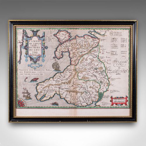 fig 1. A framed antique hand-coloured map of Wales featuring decorative cartouches, sea vessels, and an ebonised frame with a gilded inner moulding.