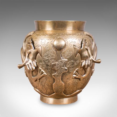 fig 1. A cast bronze urn featuring a raised dragon motif encircling the body over a chased decorative background.