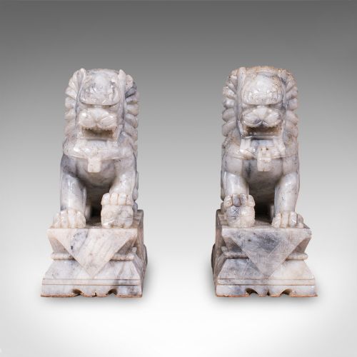 fig 2. A pair of hand-carved mottled grey soapstone guardian lion bookends mounted on carved pedestals.