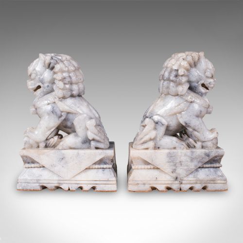fig 4. A pair of hand-carved mottled grey soapstone guardian lion bookends mounted on carved pedestals.