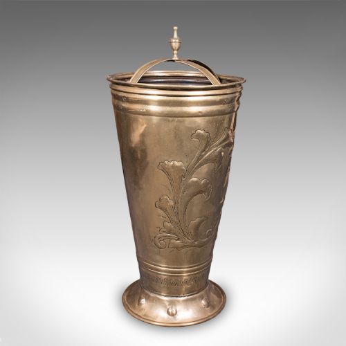 fig 2. An antique tapered brass umbrella stand featuring embossed Dutch windmill motifs, top dividers with a turned brass finial, and a flared base.