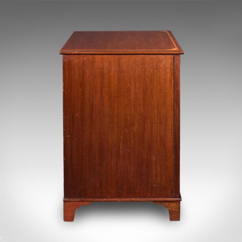 fig 3. An antique mahogany small chest of drawers featuring four graduated inlaid drawers, circular brass ring pull handles, and bracket feet.