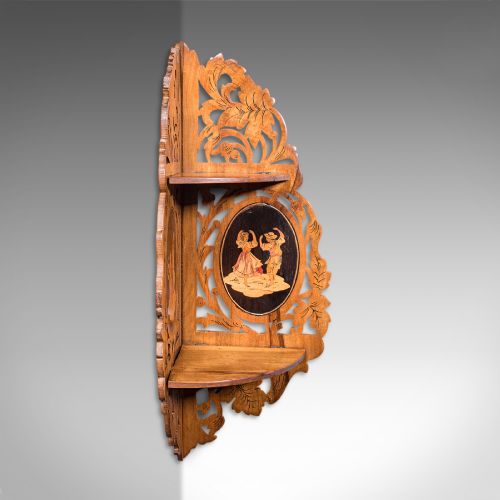 fig 2. A Victorian Italian walnut corner display shelf featuring two tiers, openwork foliage fretwork borders, and oval marquetry panels depicting folk dancers.