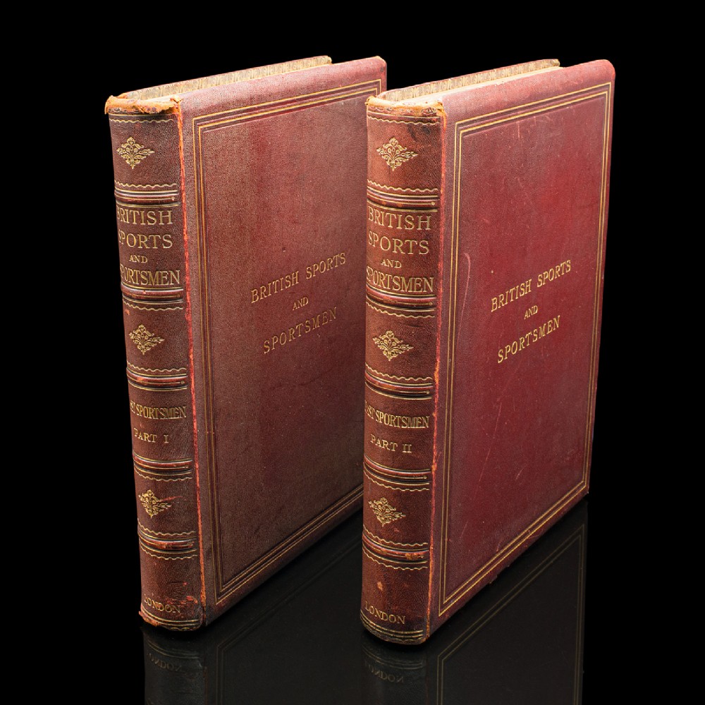 A two-volume set of antique red leather-bound books titled British Sports and Sportsmen with gilt lettering and raised spine bands.