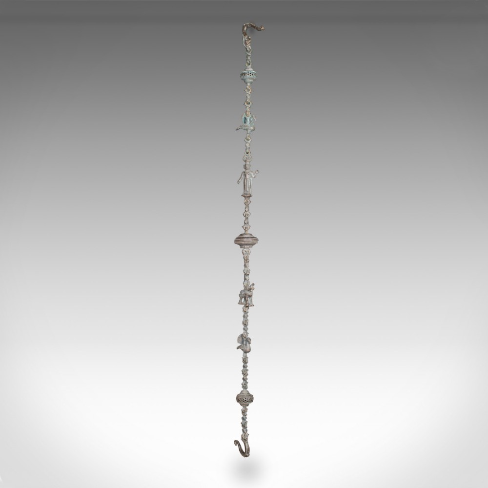 A vertical Indian bronze hanging incense burner featuring figurative link sections, rounded censer chambers, and top and bottom suspension hooks.