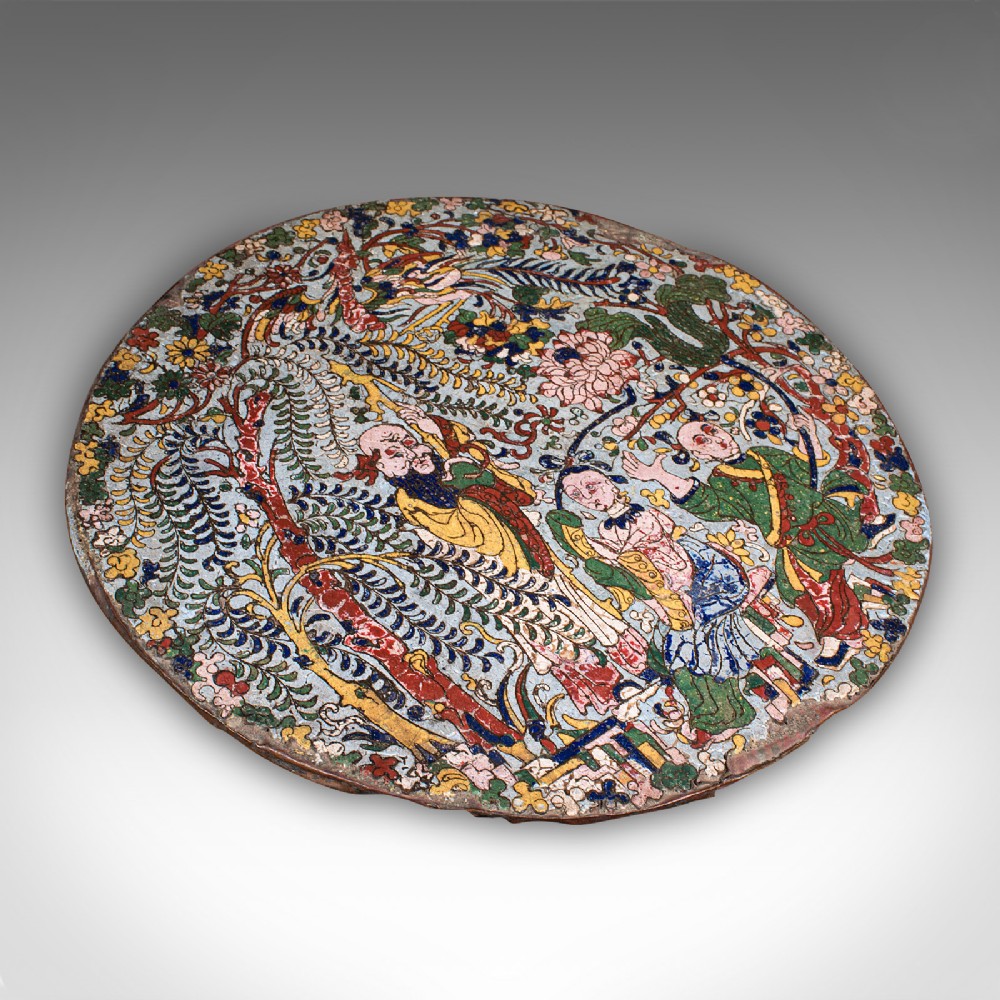 A circular Qing dynasty Chinese cloisonne enamel plaque depicting figures and weeping willow trees in polychrome colours.