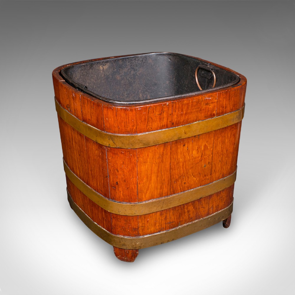 A square warm brown wooden coal bucket featuring brass binding bands and an internal black metal liner.