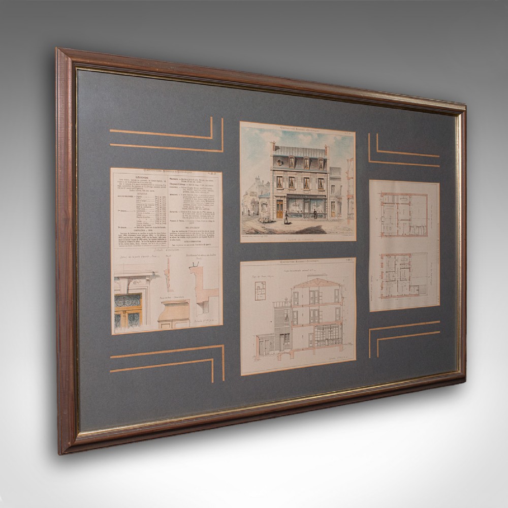 A large dark grey framed mount displaying four antique French architectural lithographs showing building elevations and structural floor plans.