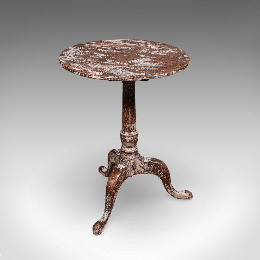 A Georgian period circular oak pedestal side table featuring a turned central column, tripod cabriole legs, and a distressed white painted finish.