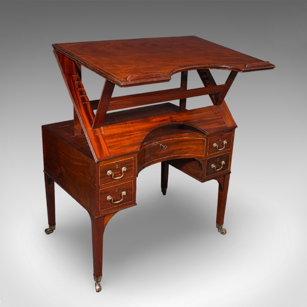 A Regency mahogany metamorphic architects desk featuring an adjustable tilted top on ratchet risers above a kneehole drawer base with brass handles.