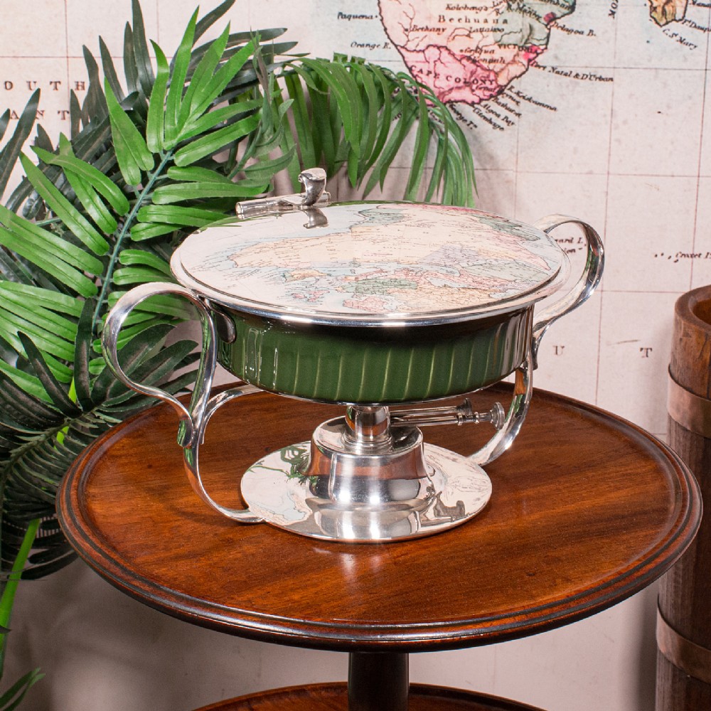 An Edwardian silver-plated chafing dish featuring a ribbed green ceramic liner, double loop handles, a fitted lid, and an integrated spirit burner base.