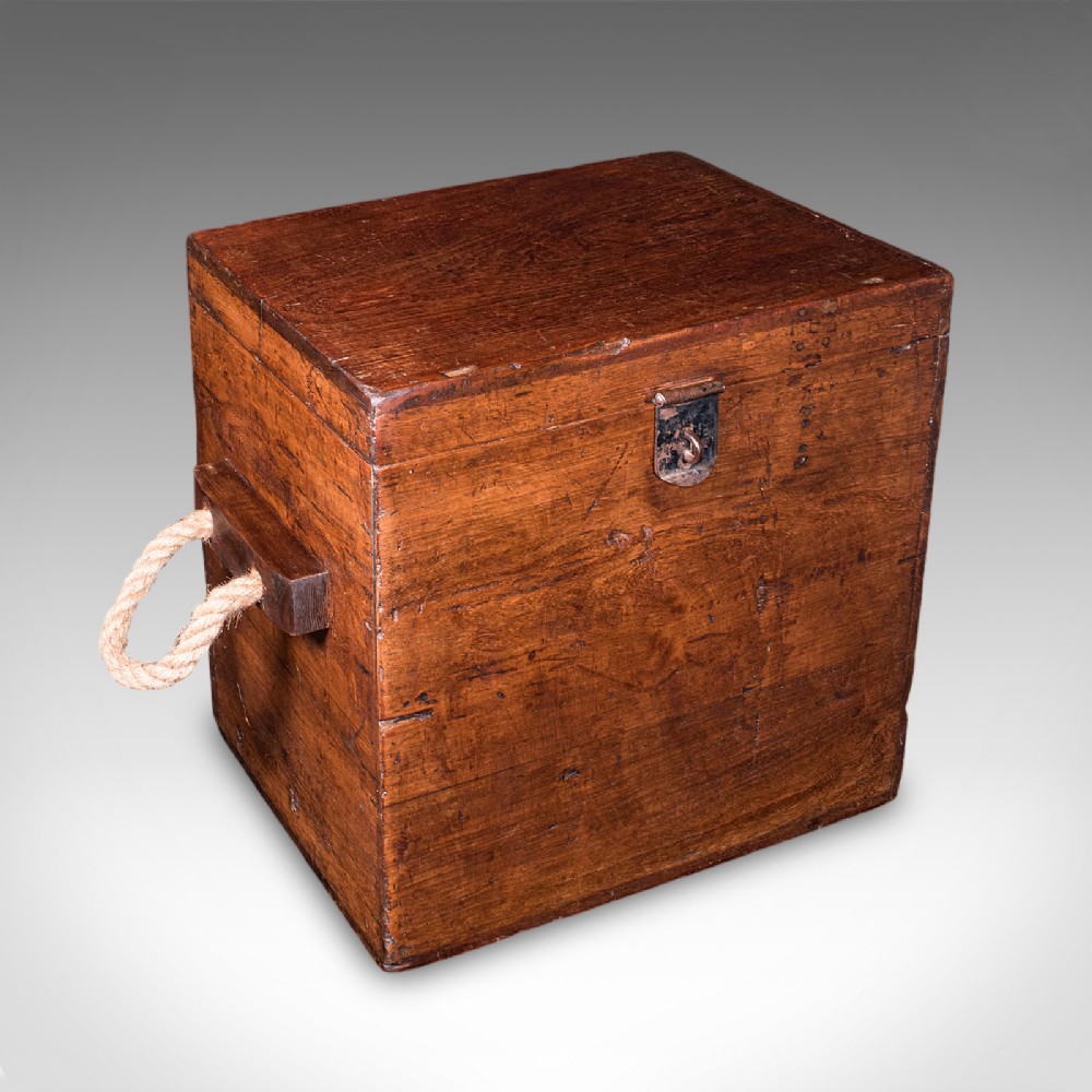 A Georgian walnut maritime decanter box featuring side rope handles and an iron front latch.