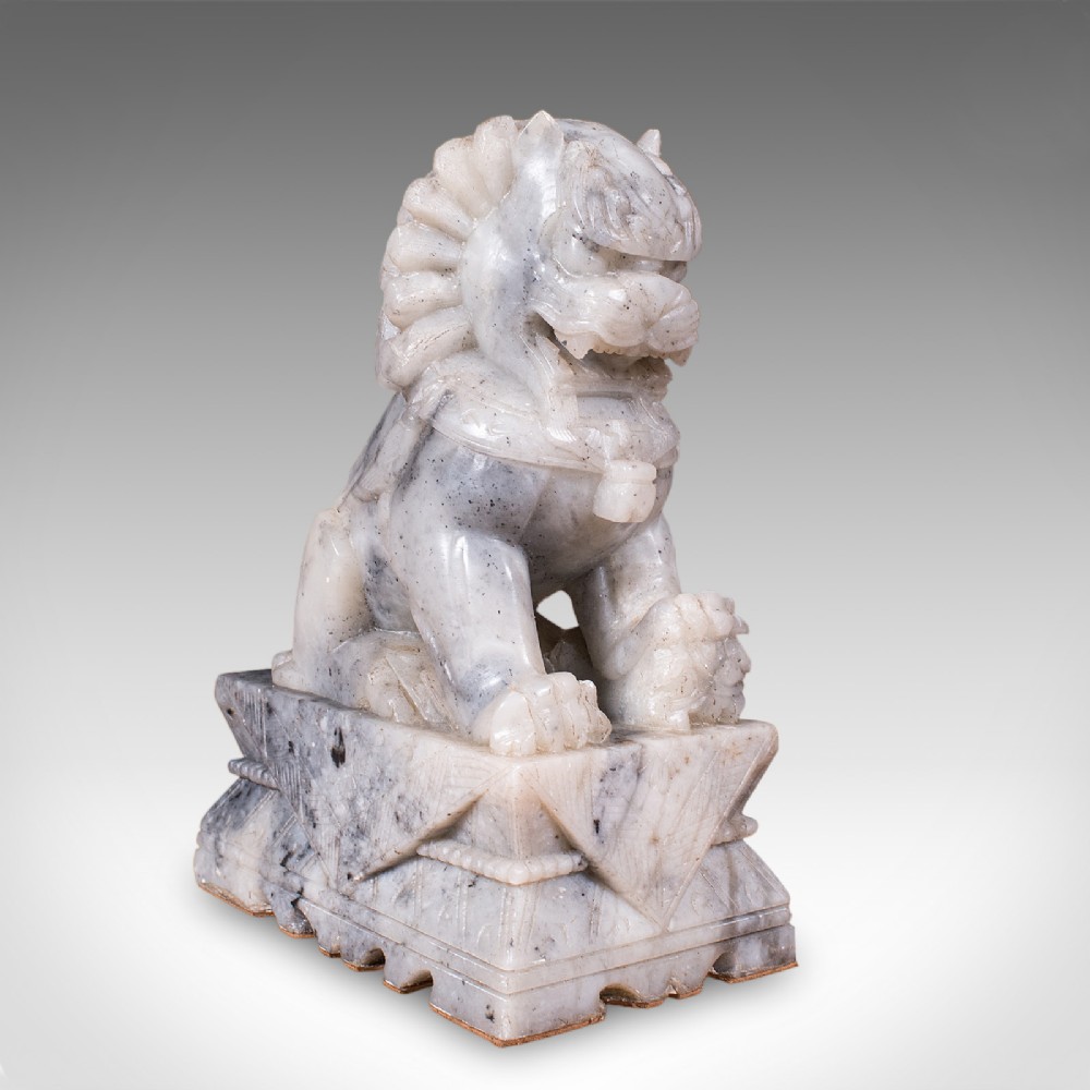 A pair of hand-carved mottled grey soapstone guardian lion bookends mounted on carved pedestals. View VI
