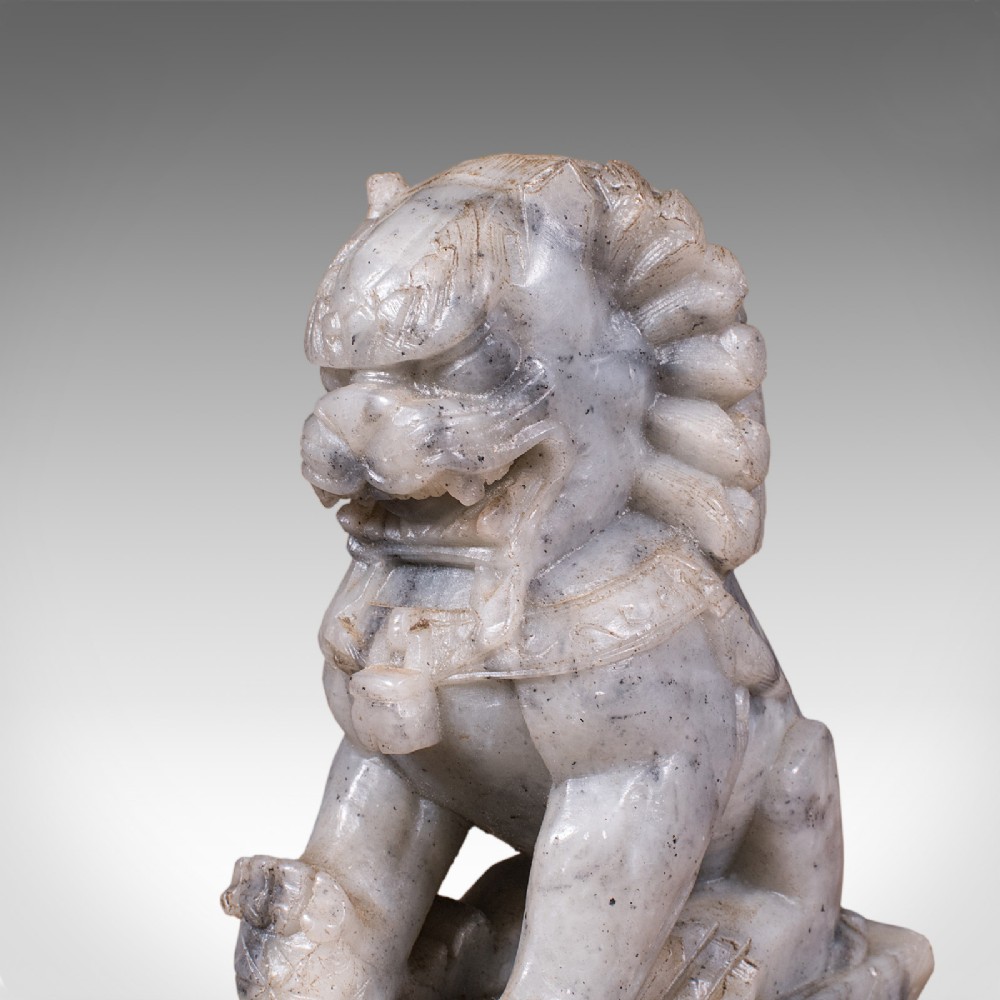 A pair of hand-carved mottled grey soapstone guardian lion bookends mounted on carved pedestals. View XI