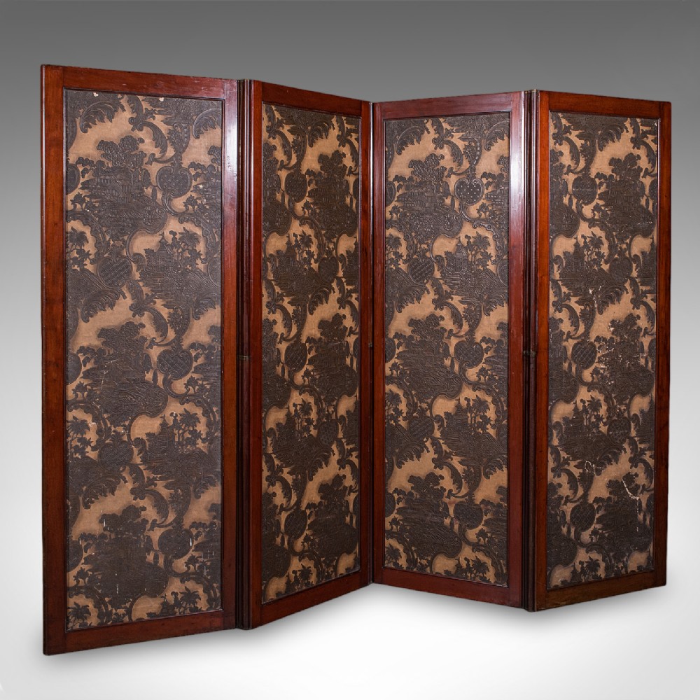 A four-panel mahogany folding room divider featuring patterned chinoiserie canvas panels set within dark wood frames.