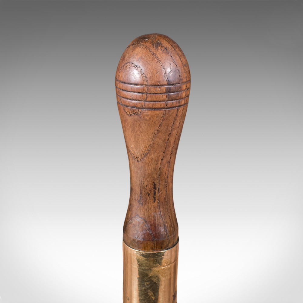 Victorian hand bell featuring a polished brass bell body with a turned beech handle set on a circular wooden stand. View VIII